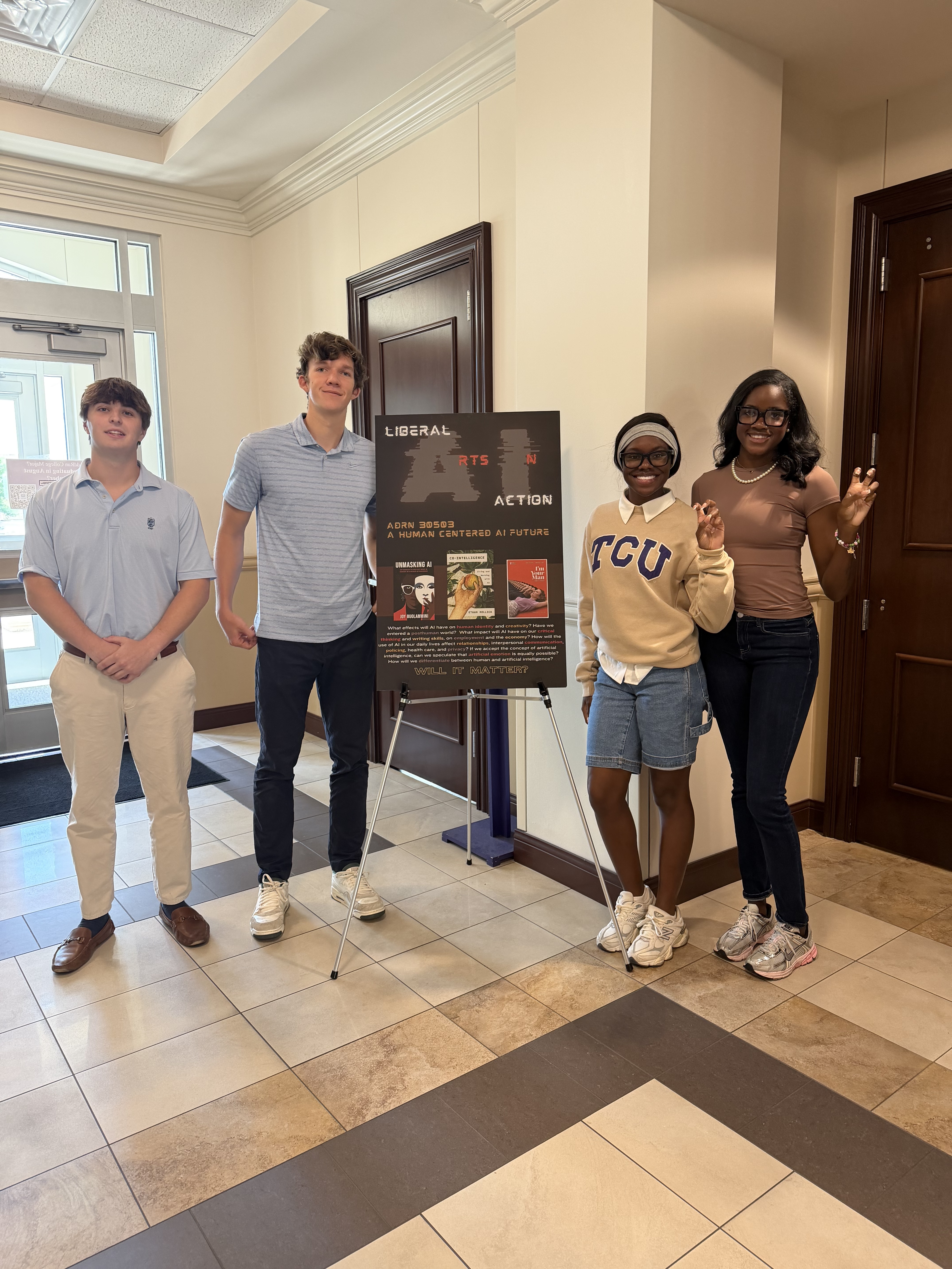 TCU students stand beside a poster for A Human-Centered AI Future.