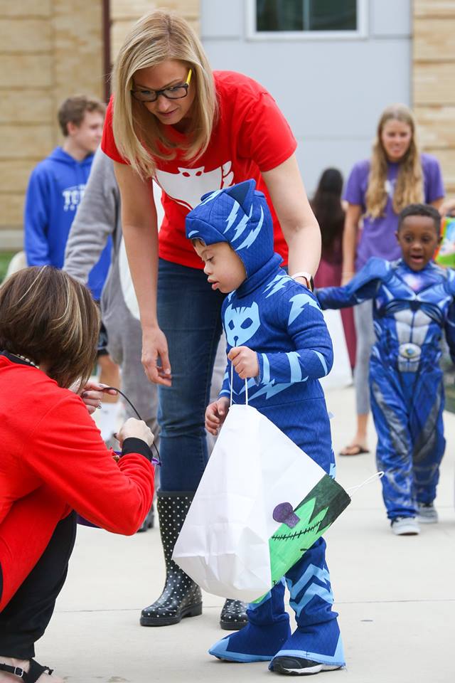 Kinderfrogs students trick-or-treating in the campus commons