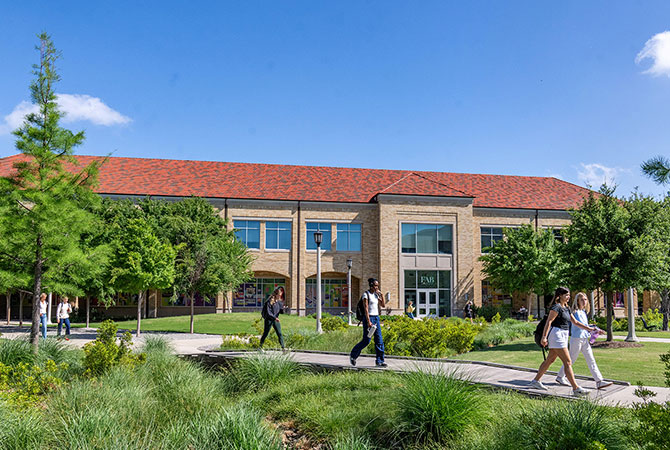 TCU students walking near the Fine Arts Building
