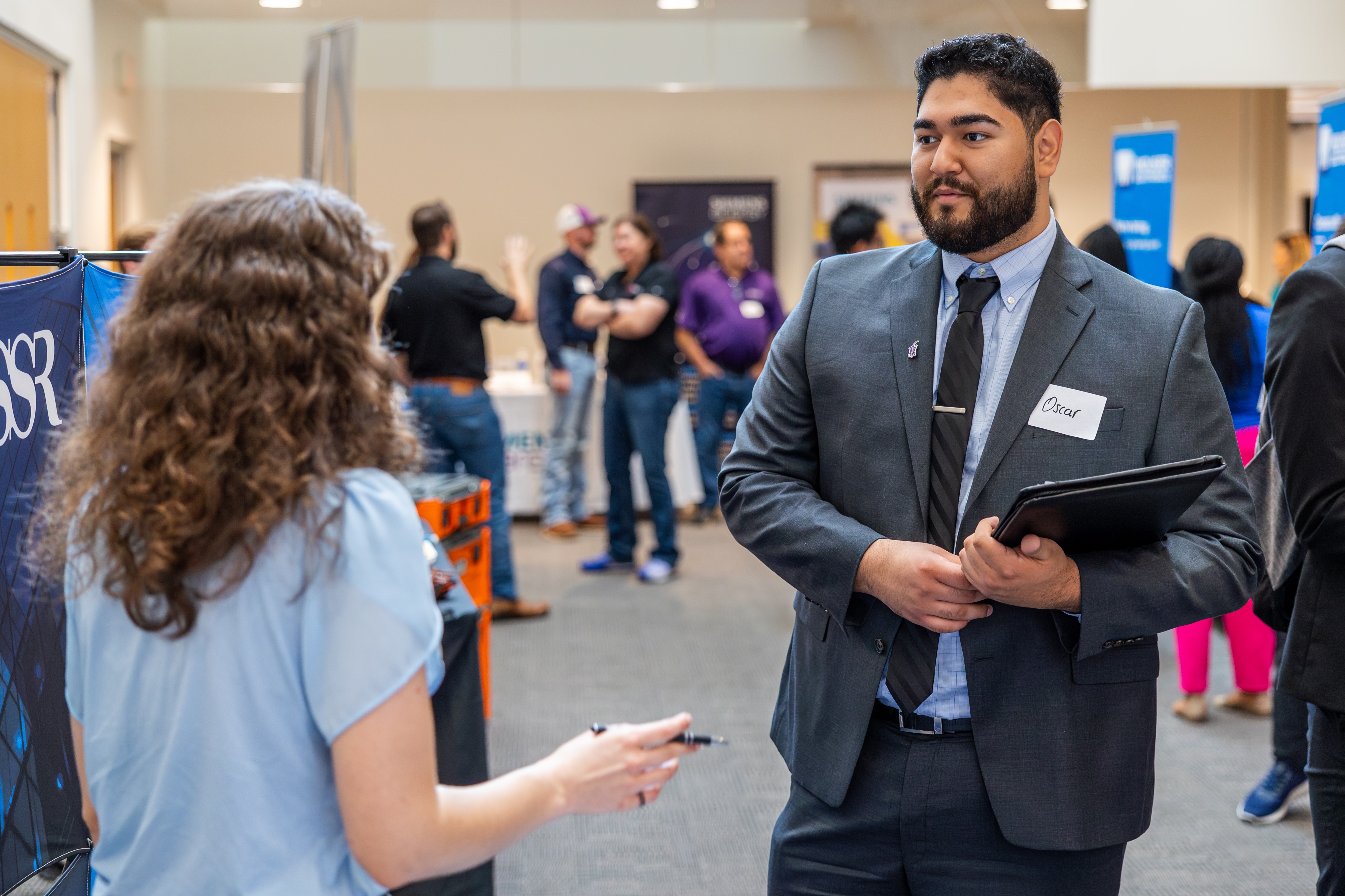 Engineering and Technology students connect with representatives from various companies and learn about opportunities for internships and jobs at the Engineering & Technology Fair in the Tucker Technology Center, October 2, 2024. Photo by James Anger.