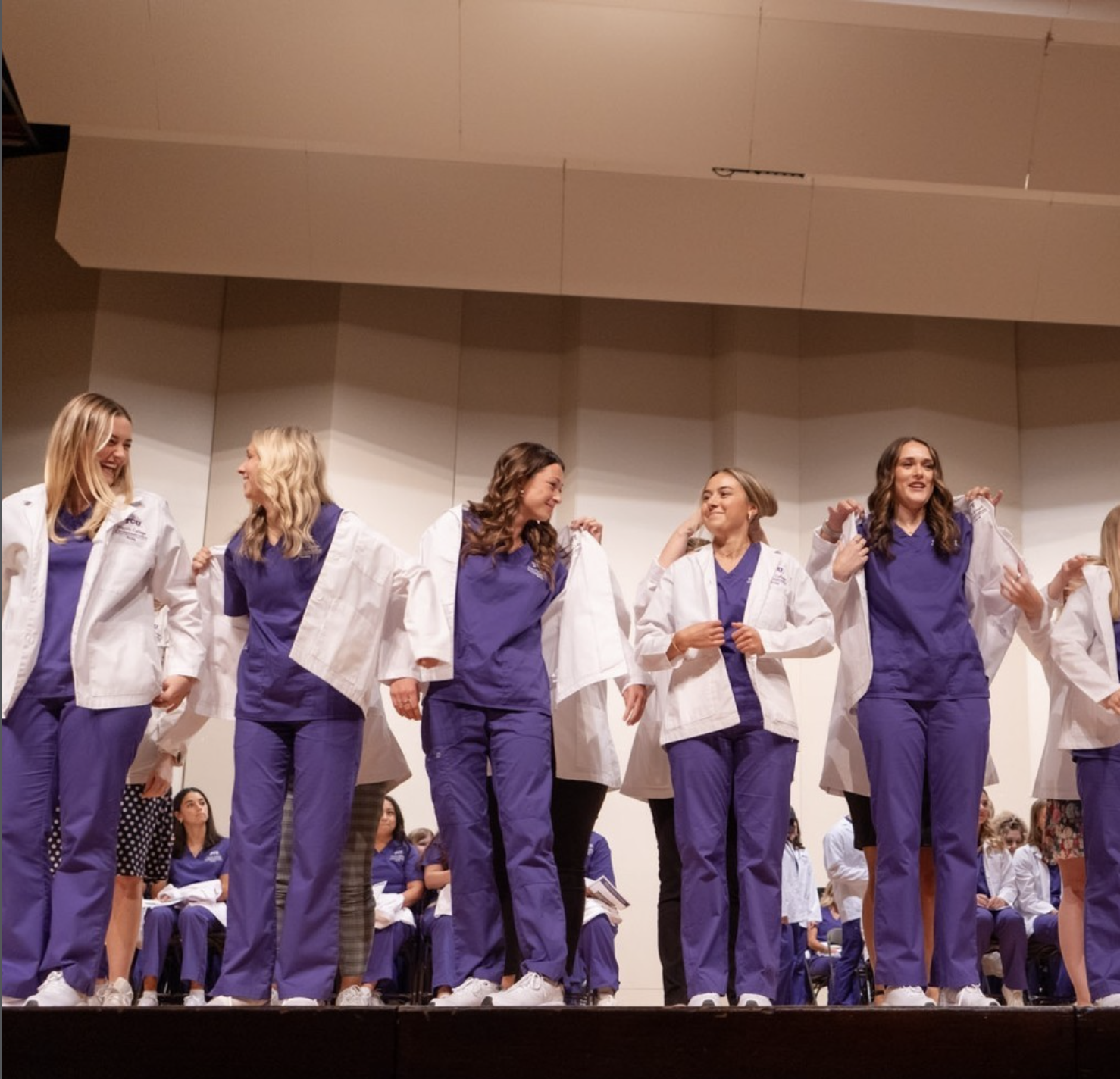 Nursing students receive their white coats.