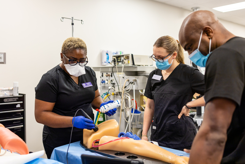 TCU nursing students working on mock patient limb