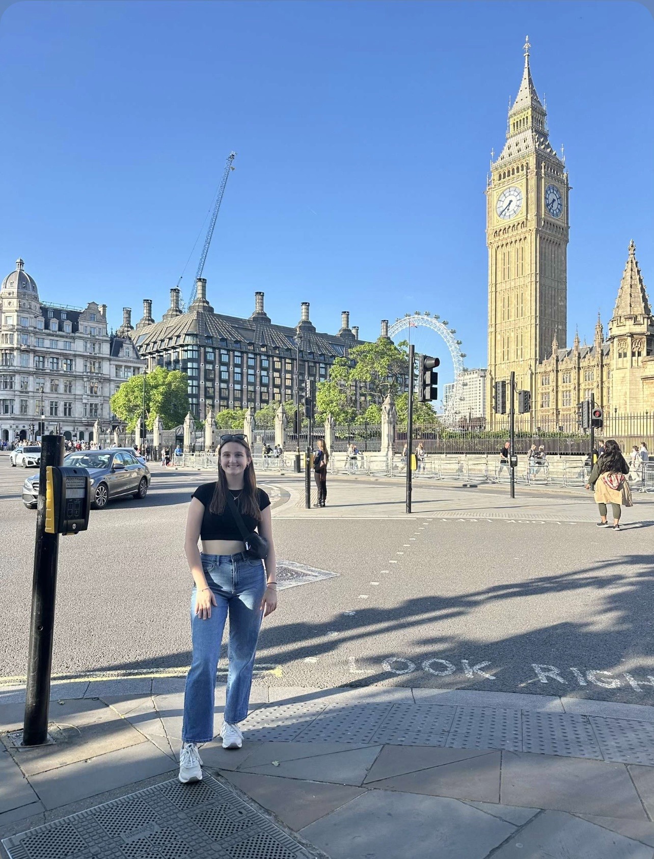 TCU Student Bella R. posing for a picture infront of Elizabeth Tower 