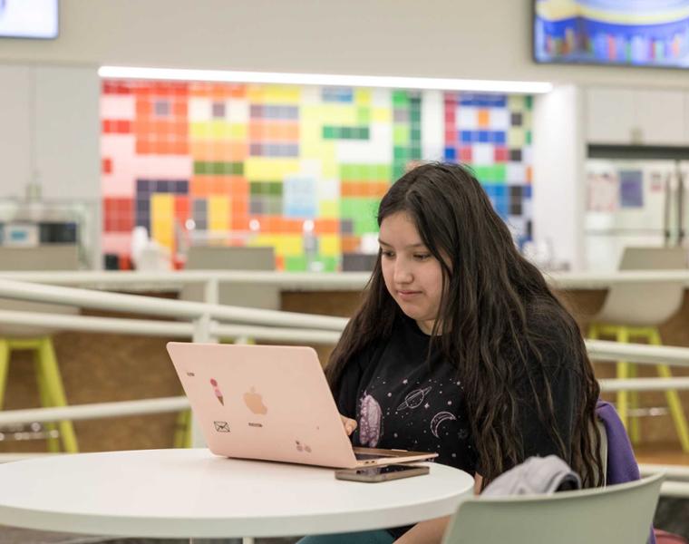 Female student on laptop in the Intercultural Center