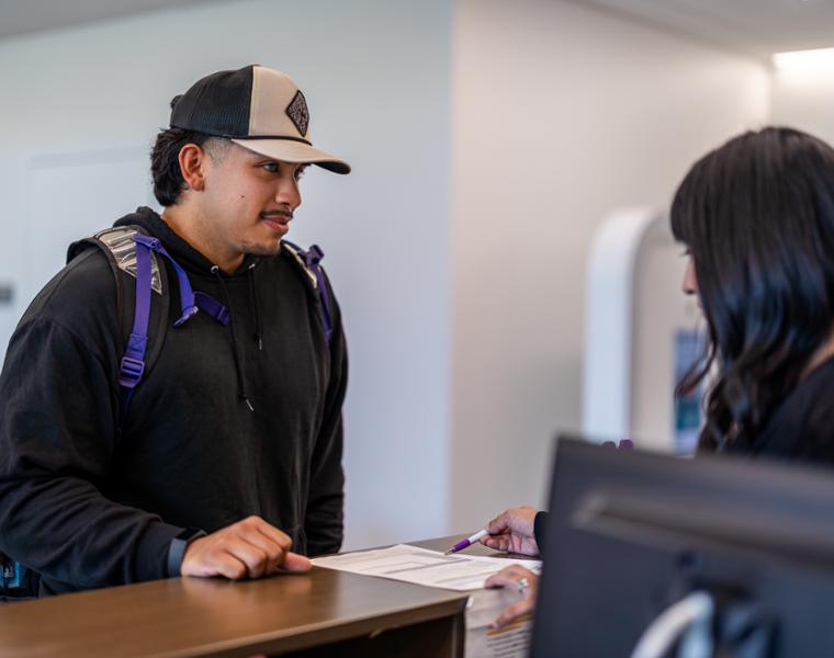 Male student talking to TCU staff member