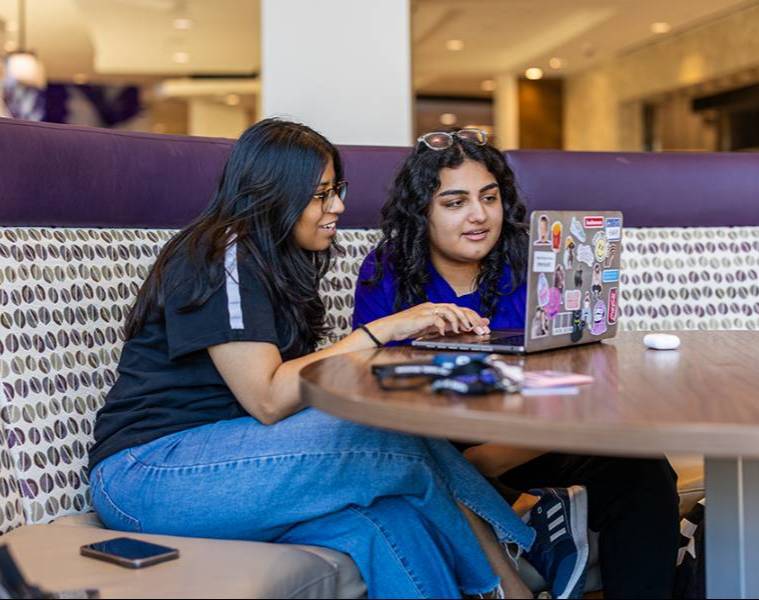 TCU students on their laptop