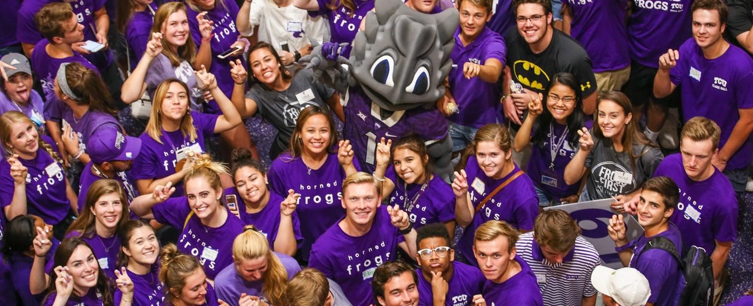 A group of students gathered around SuperFrog