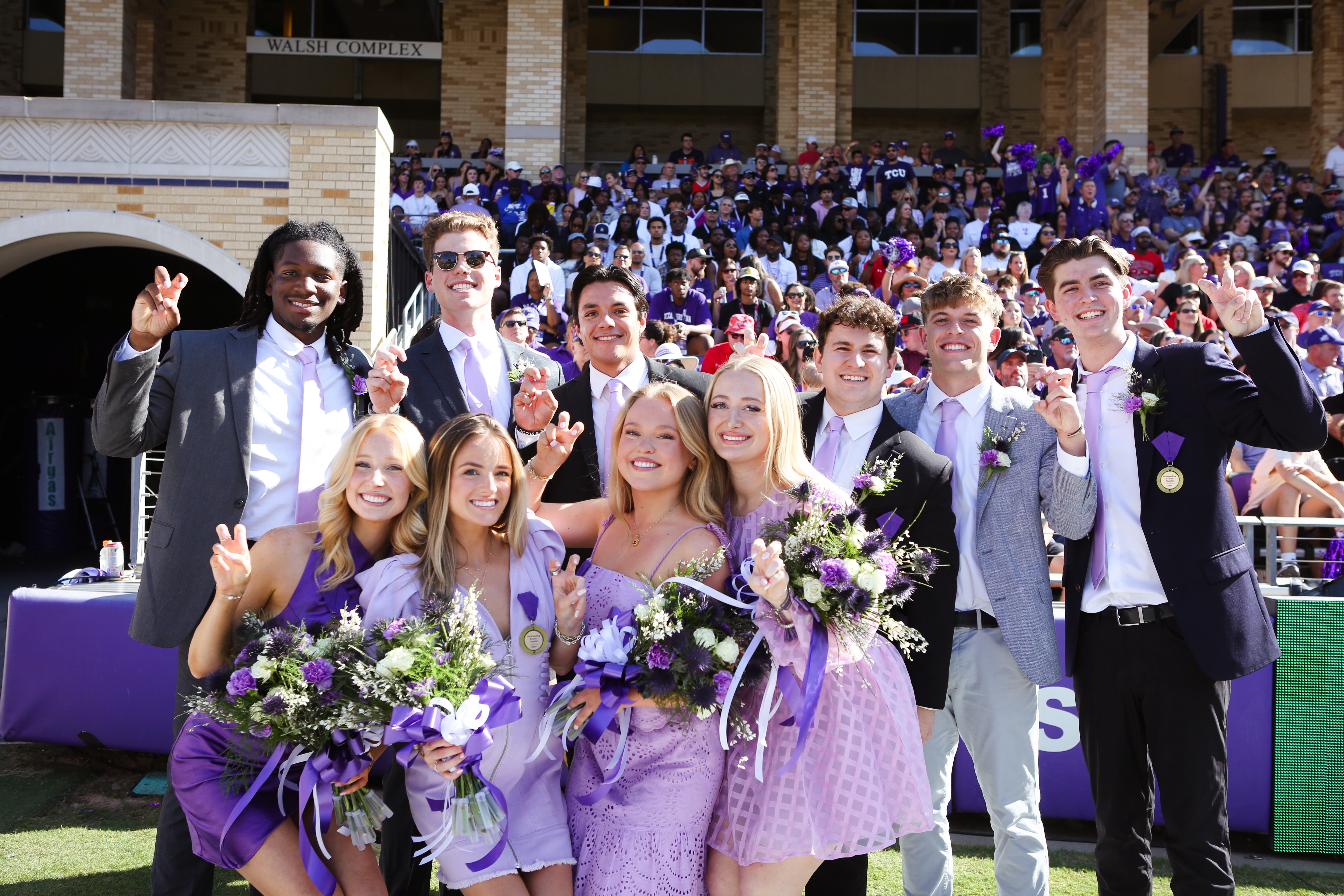 The nominees for Outstanding Senior 2024 line up for a photo during halftime at TCU's homecoming game against Texas Tech., October 26, 2024. Shown, from left, front row: Ally Hajduk, Isabel Gunderson, Olivia Hanson and Sophia Smith; back row: Oreoluwayimika (Oreo) Adebanjo, Lawson Ewing, Cooper Krudwig, Dominic (Dom) Mendlik, Luke Swan and Ryan Thorpe. Photo by Amy Peterson.
