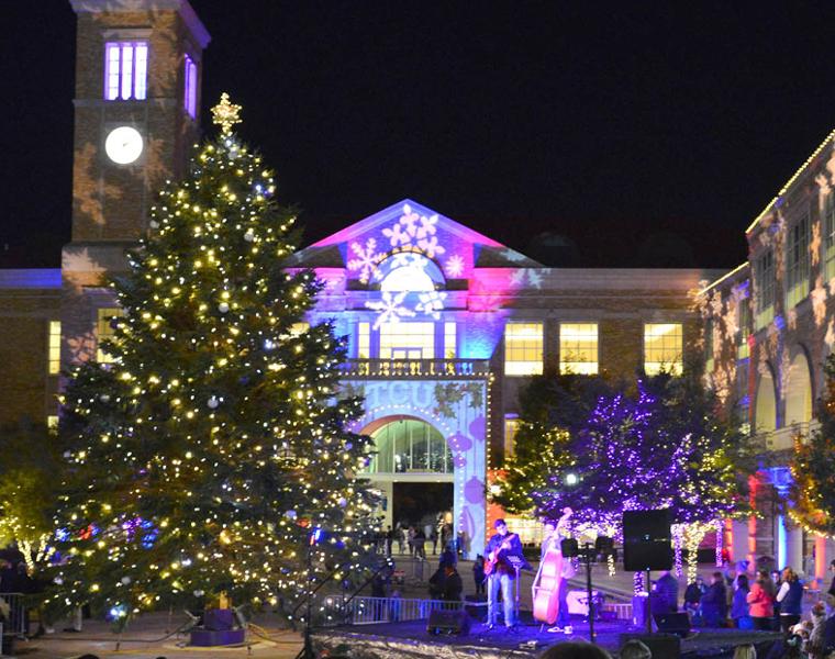 TCU Christmas Tree lit up in front of the BLUU archway 